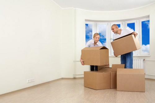 Removal team handling boxes and furniture in a Bayswater flat move