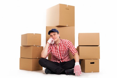 Professional movers carrying furniture through a Bayswater apartment building